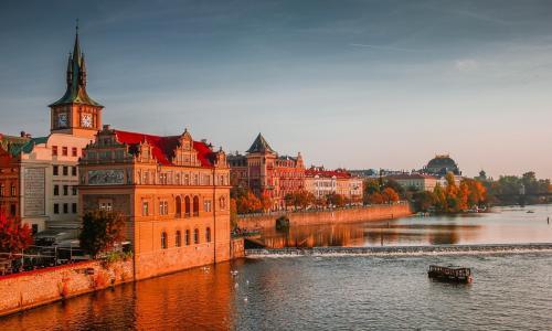 sunset over buildings by the water